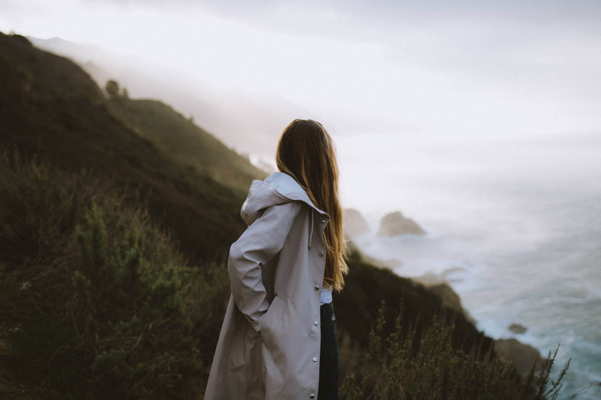 woman wearing stutterheim light sand rain jacket at Big Sur California Coast