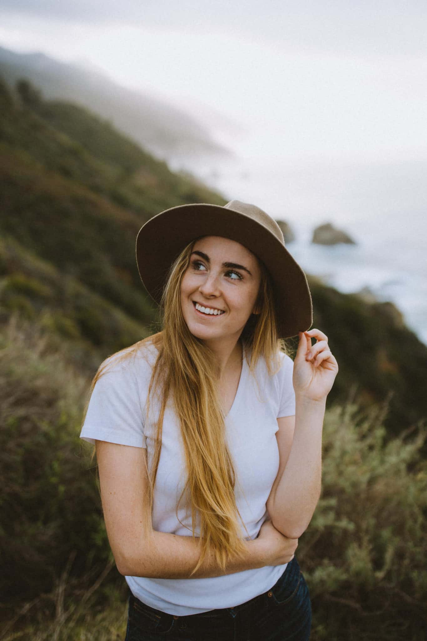 Emily Mandagie posing with at at Big Sur California Coast