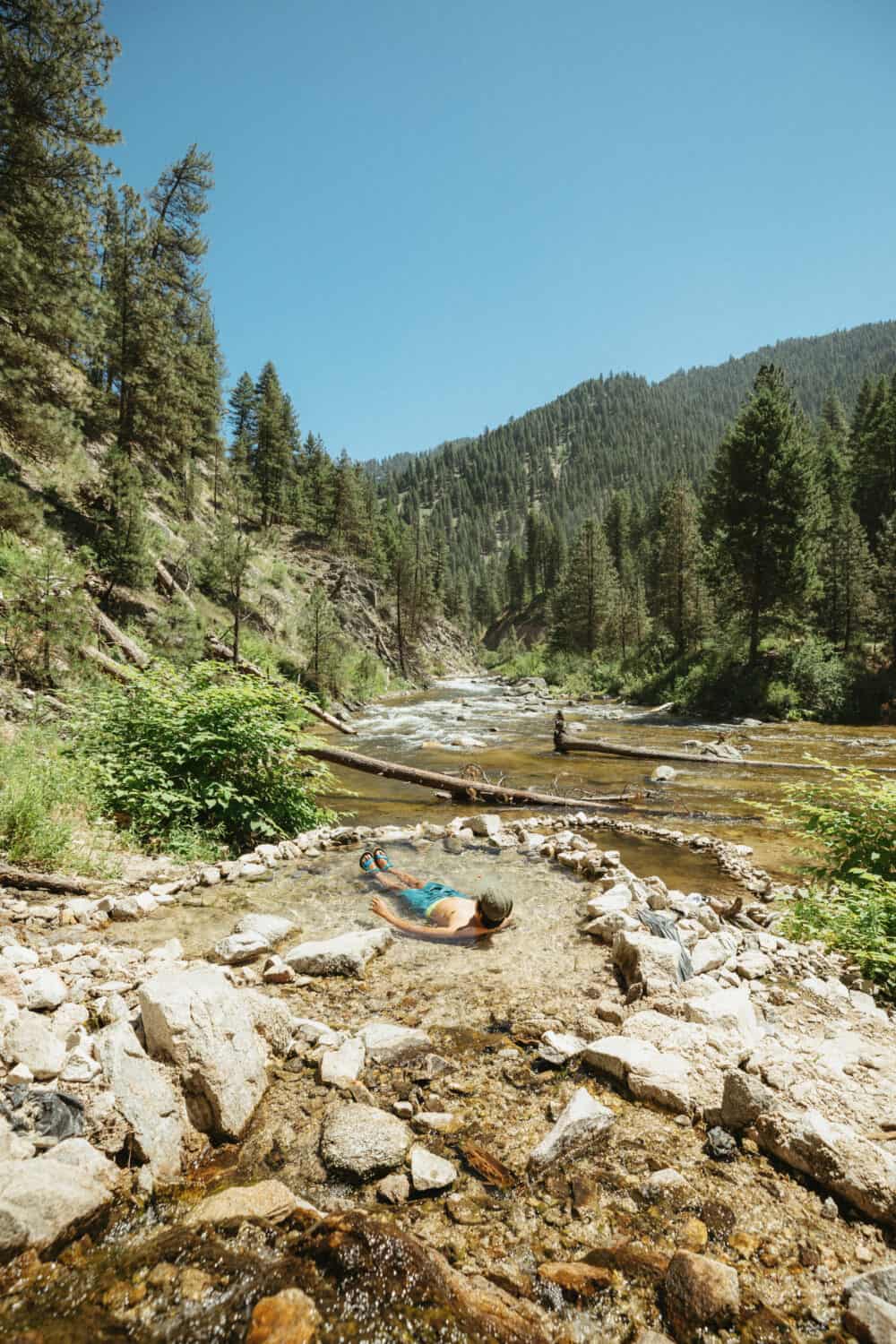 Berty Mandagie soaking in tiered pools at Rocky Canyon Hot Springs