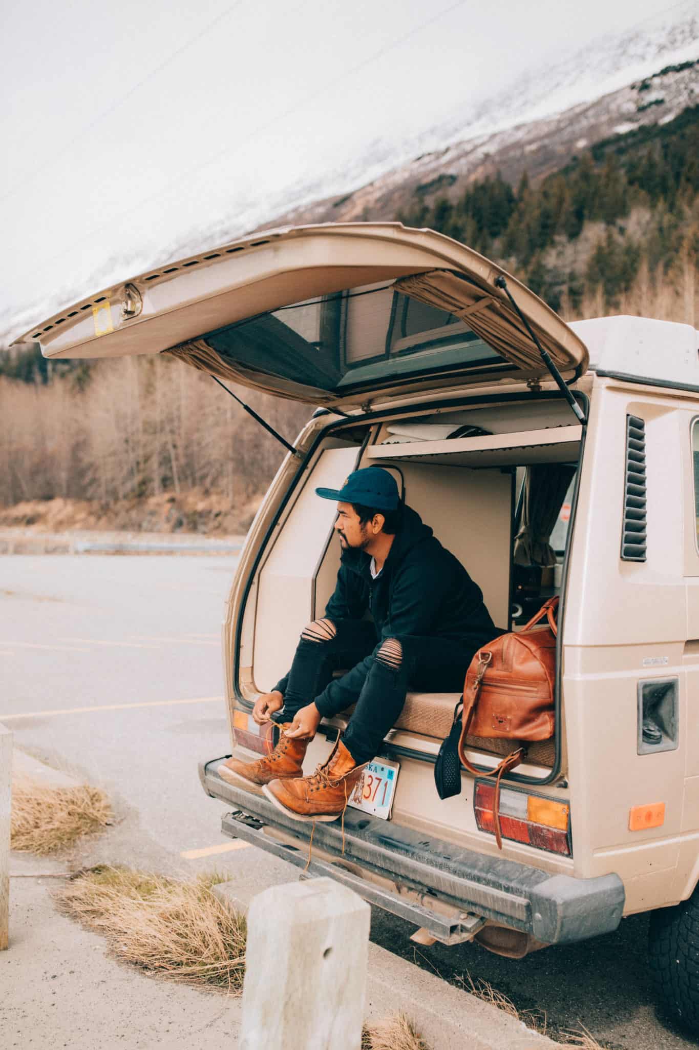 Berty Mandagie sitting in back of VW Westfalia