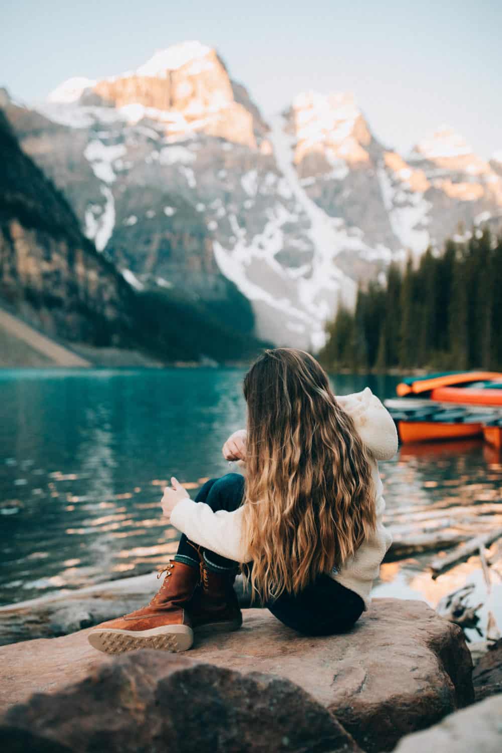 Moraine Lake Sunrise - Emily Mandagie wearing Red Wing Boots near colorful canoes