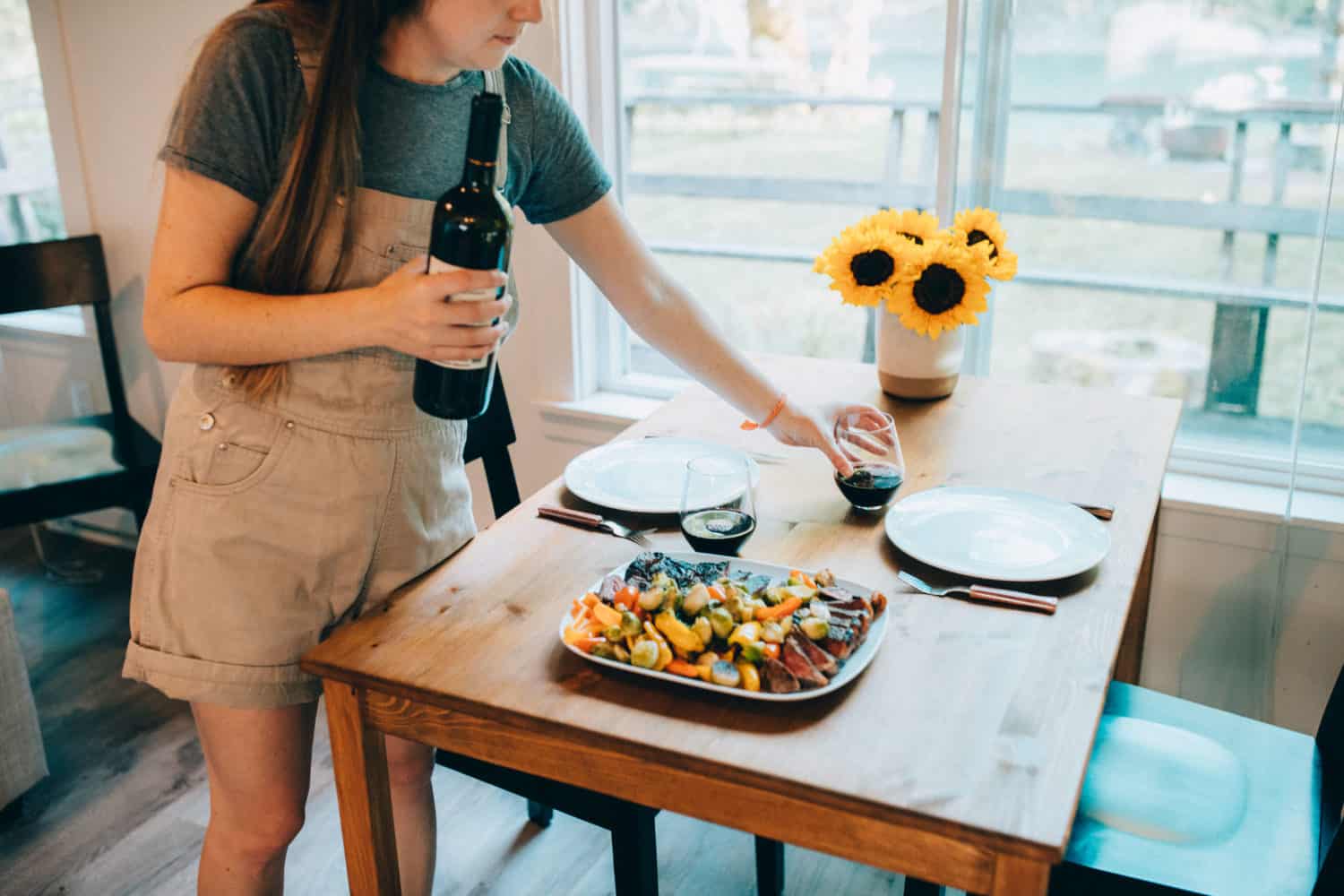 Emily Mandagie setting dining room table