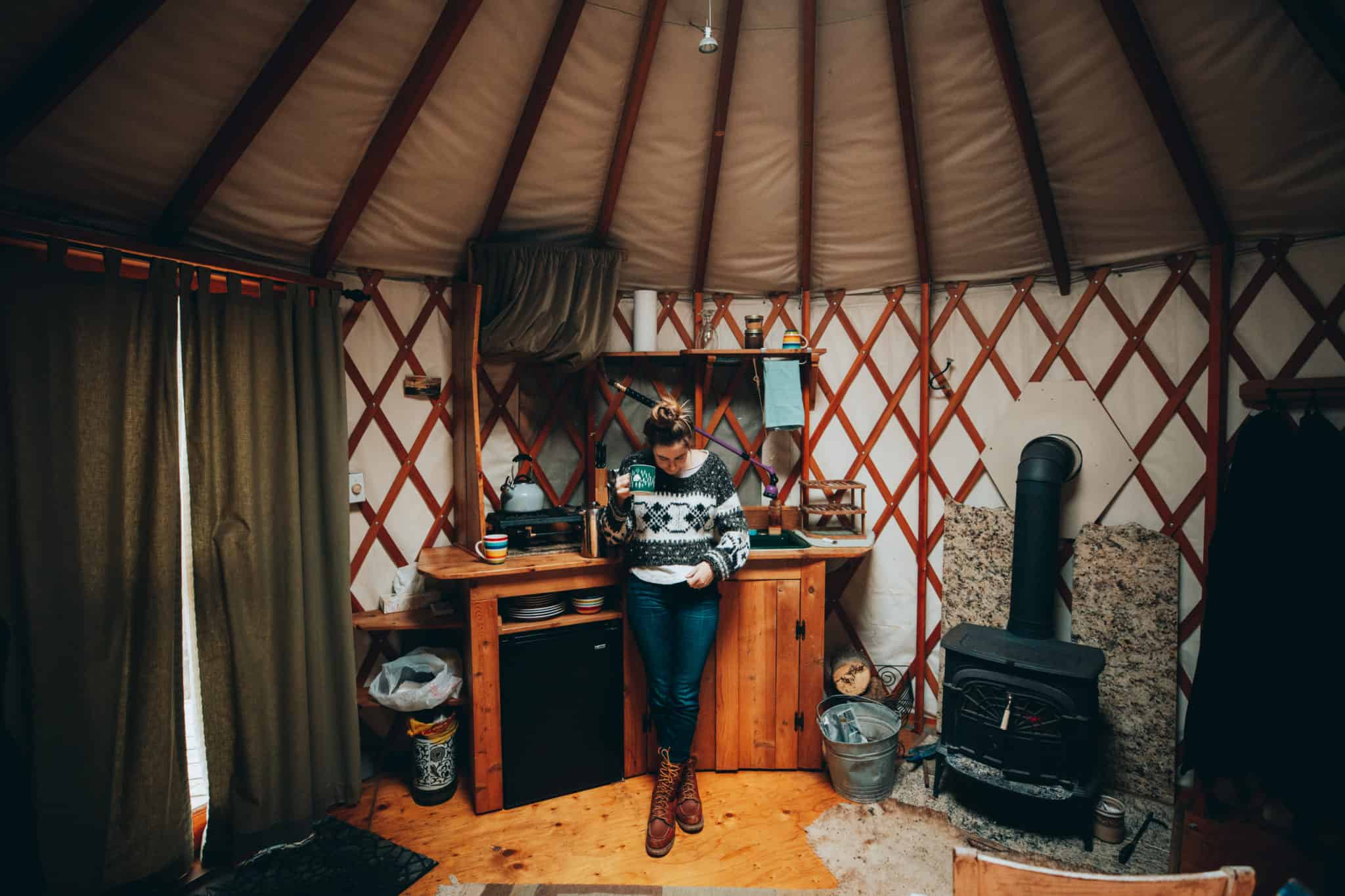 emily inside yurt with coffee mug