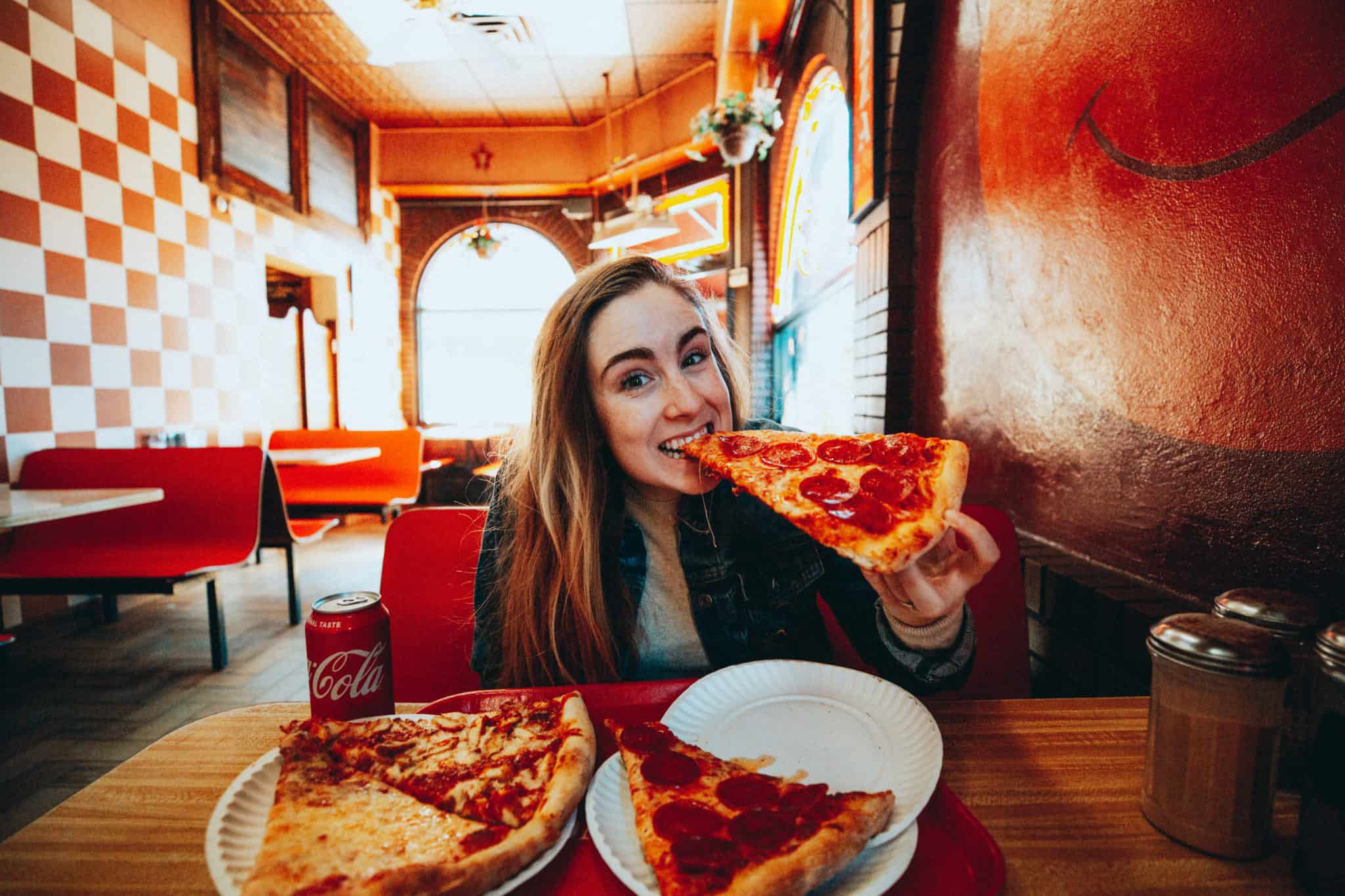 Emily eating pizza - Food Spots In NYC