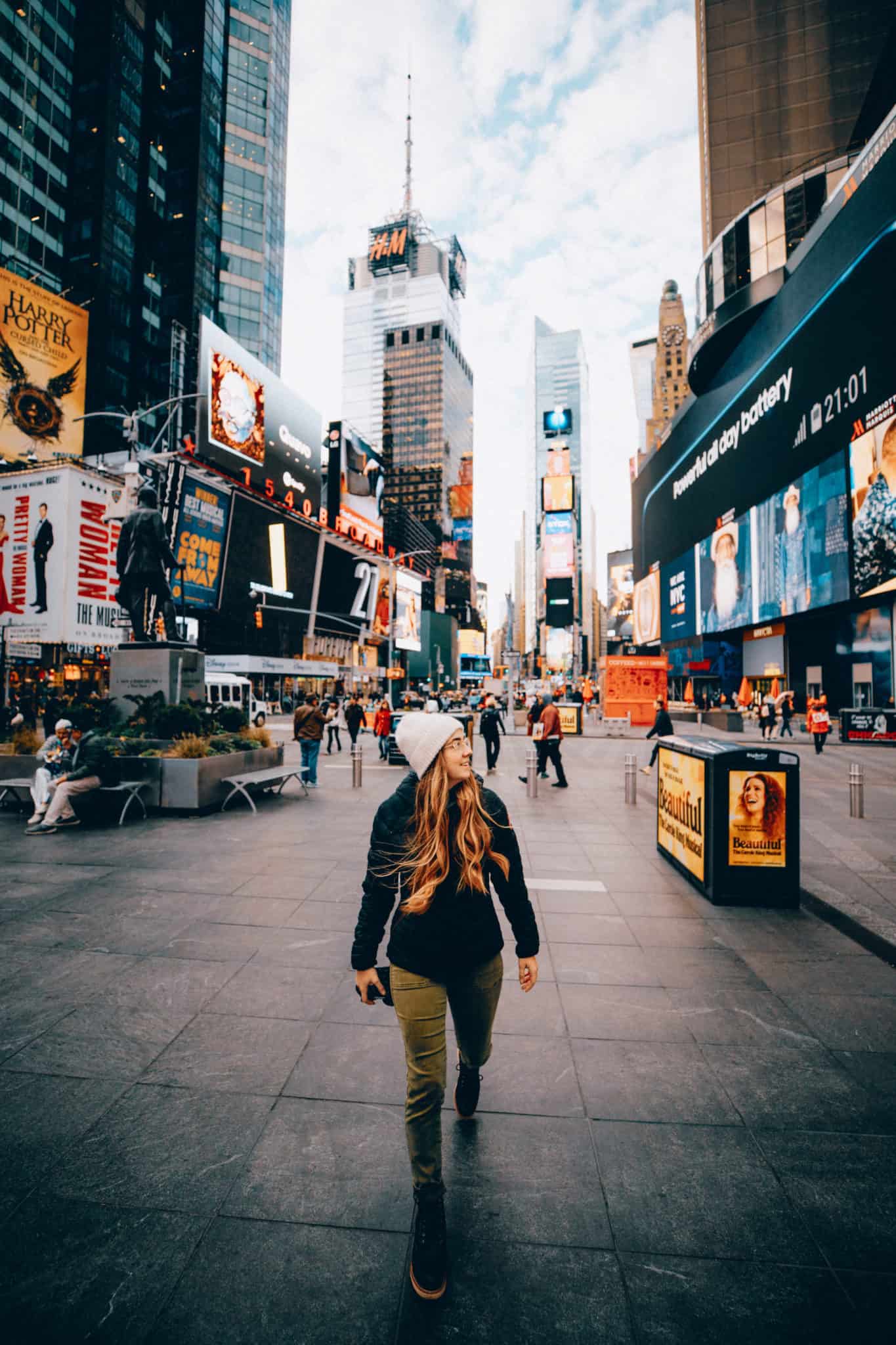 Emily Mandagie walking in Times Square NYC - TheMandagies.com