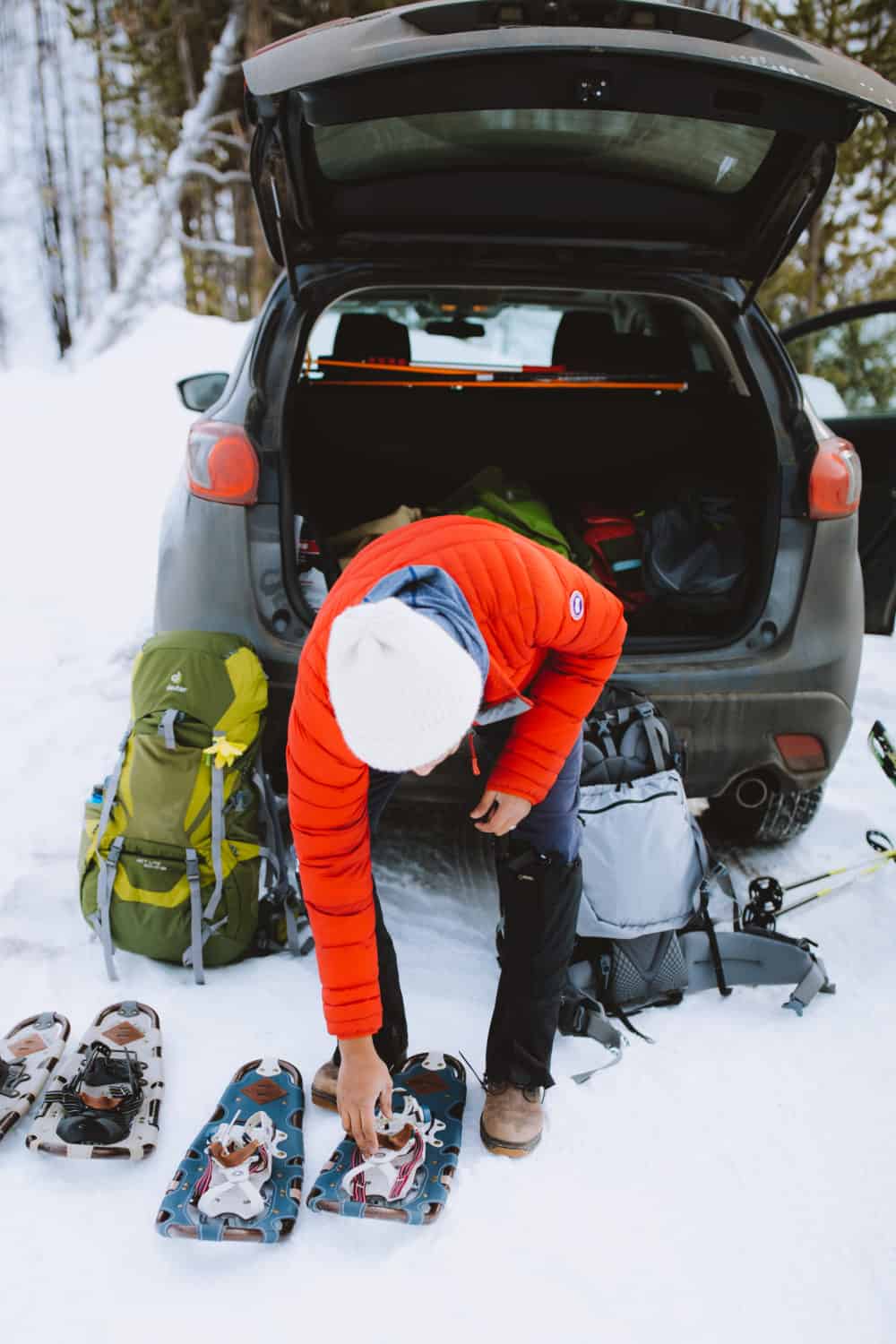 Berty Mandagie preparing snowshoes for Idaho city snowshoe trails