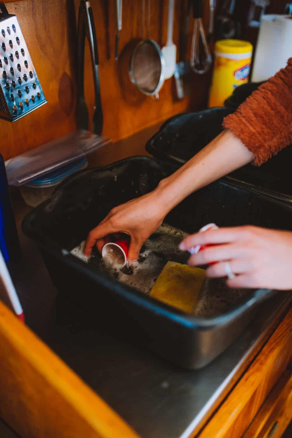 cleaning dishes in bucket