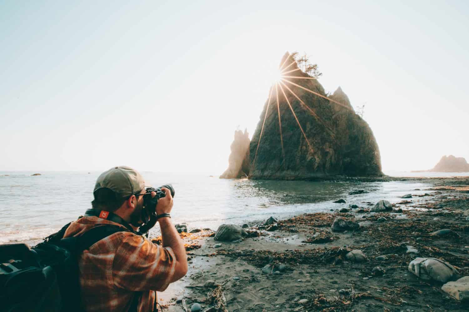 Man taking photo of sea stack Rialto Beach - TheMandagies.com