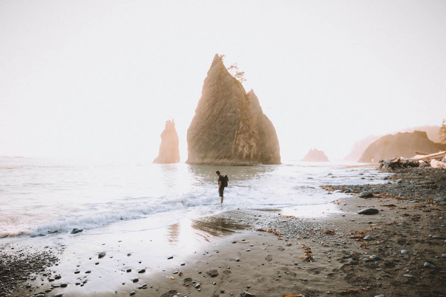 Berty Mandagie standing on shore at Rialto Beach, Washington, Olympic National Park