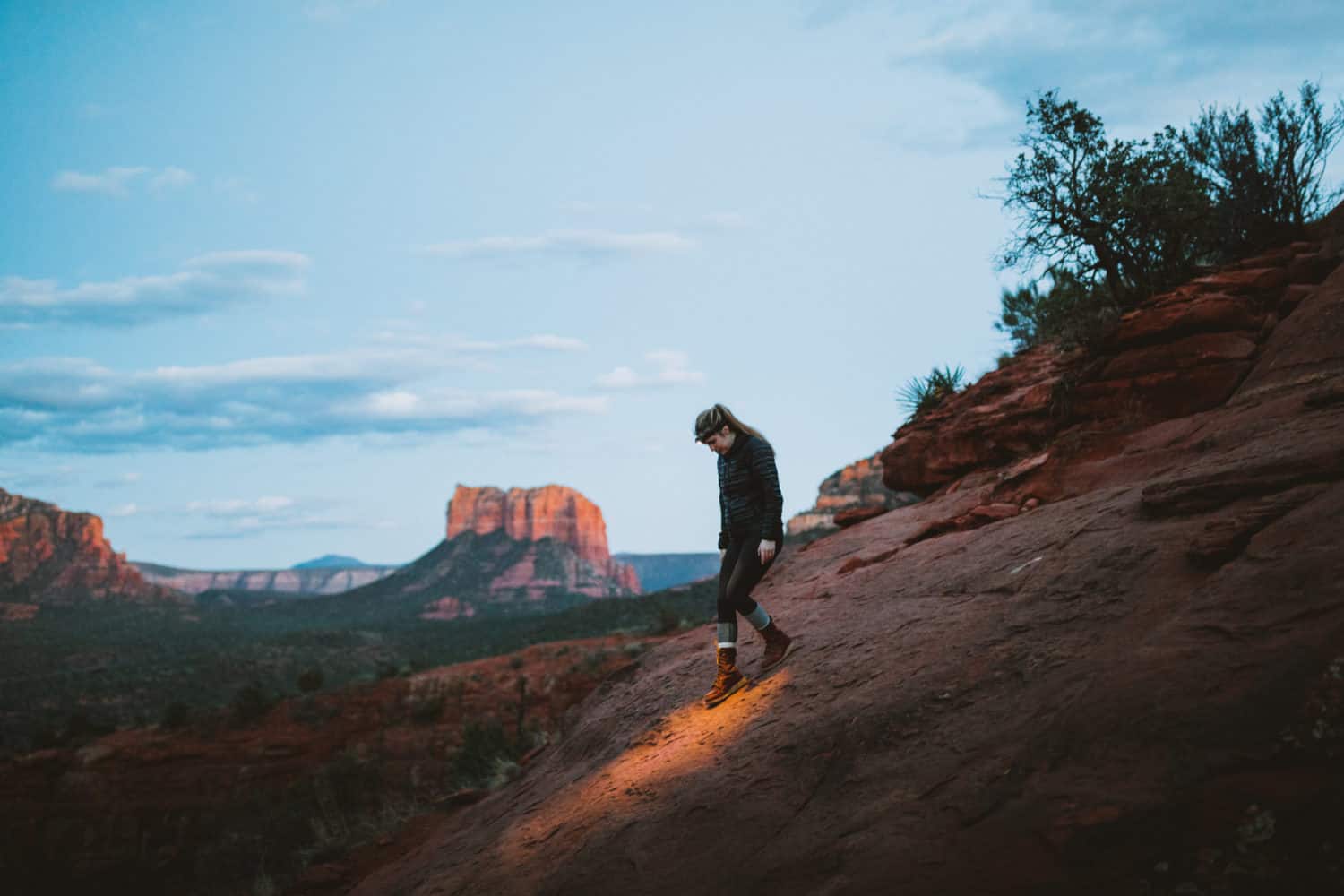 Emily walking down Cathedral Rock trail after sunset with headlamp - TheMandagies.com