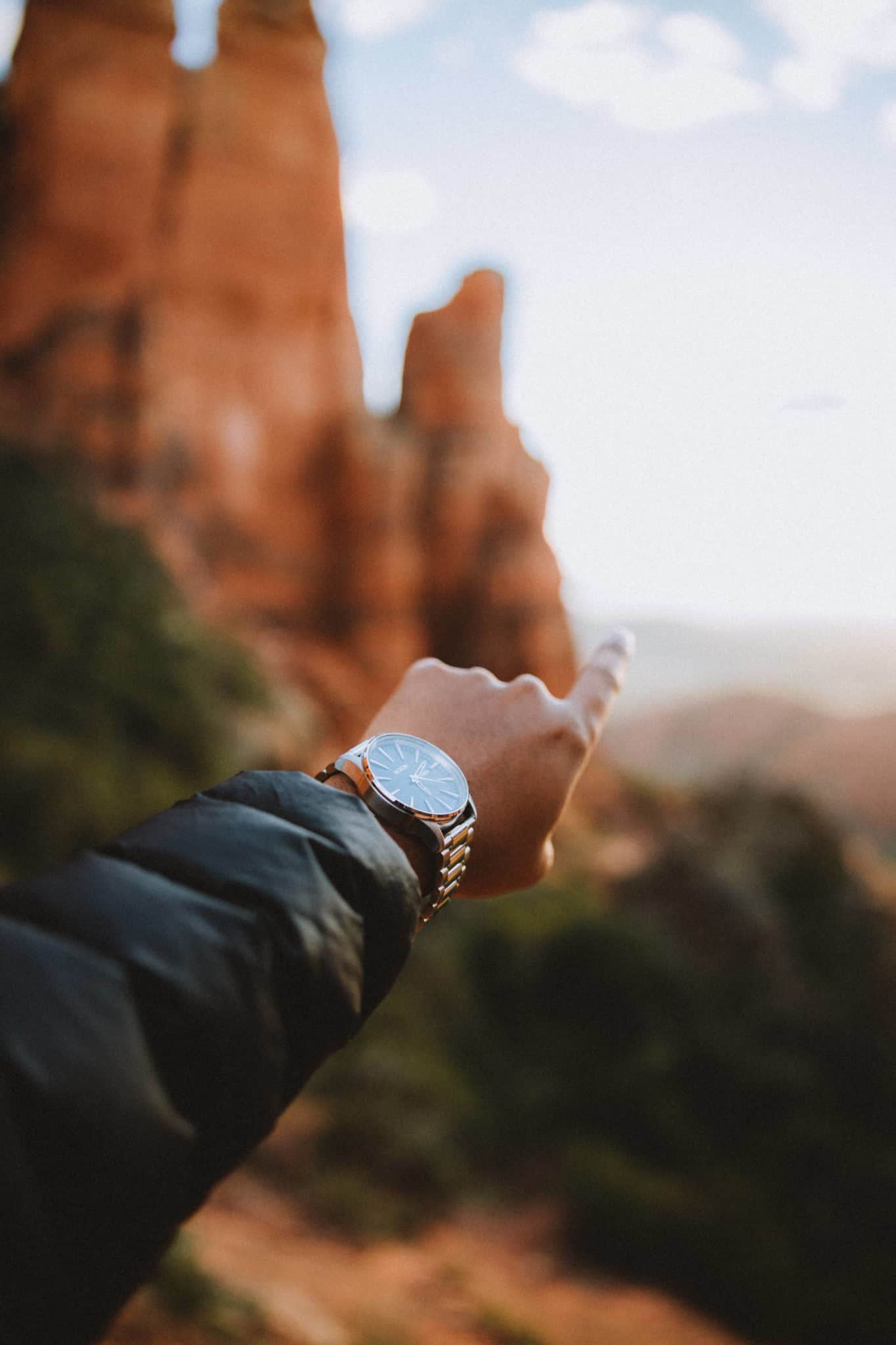 Berty pointing to sunset at Cathedral Rock - TheMandagies.com