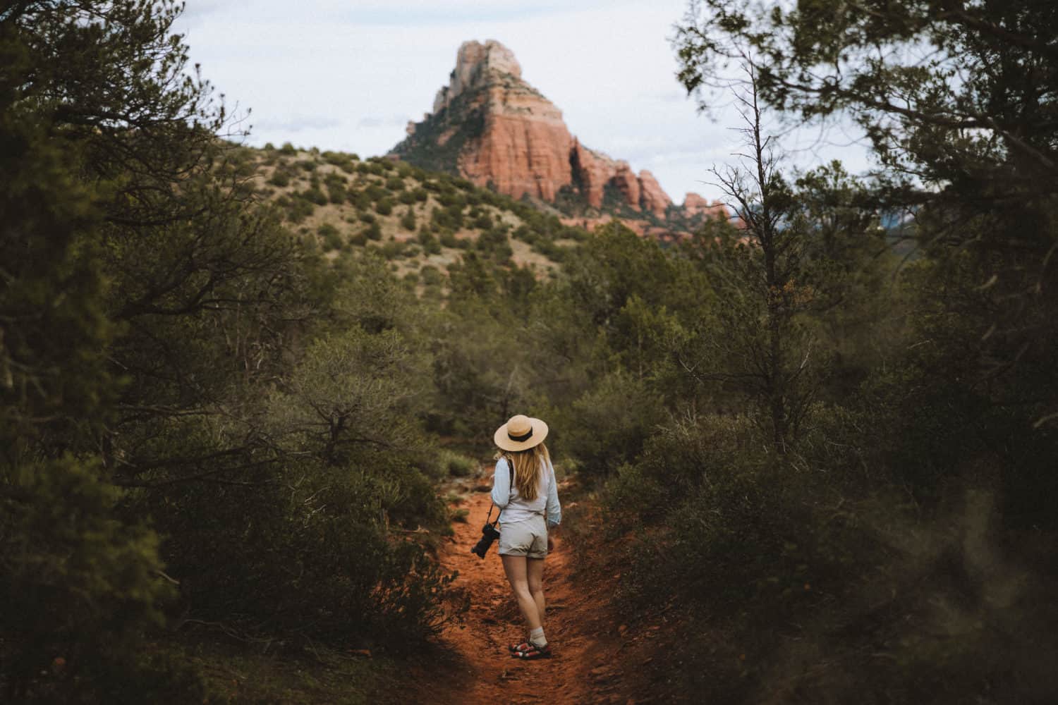 Emily looking at rock cliff in Sedona - TheMandagies.com