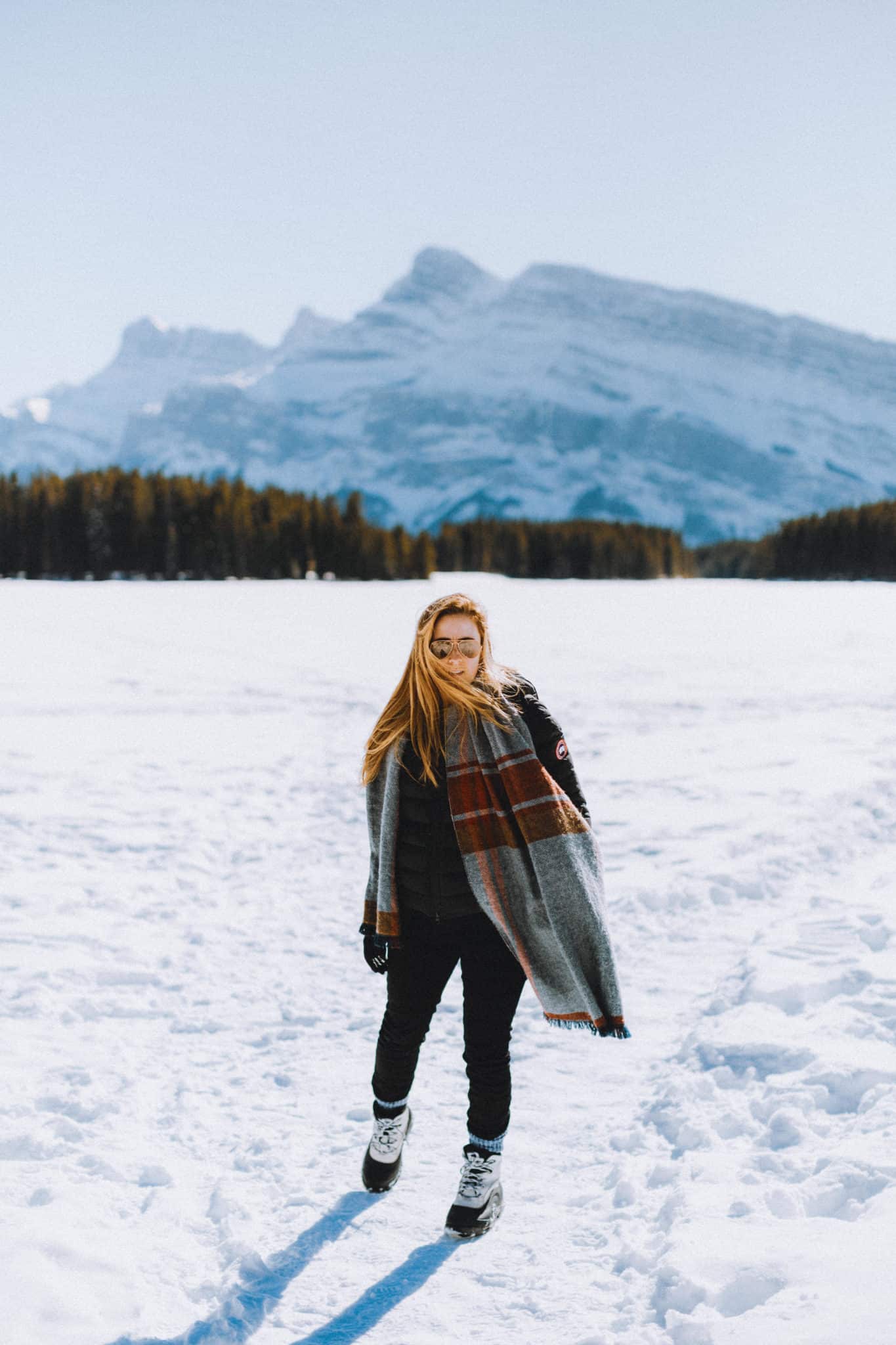 Emily Mandagie standing on frozen Two Jack Lake - TheMandagies.com