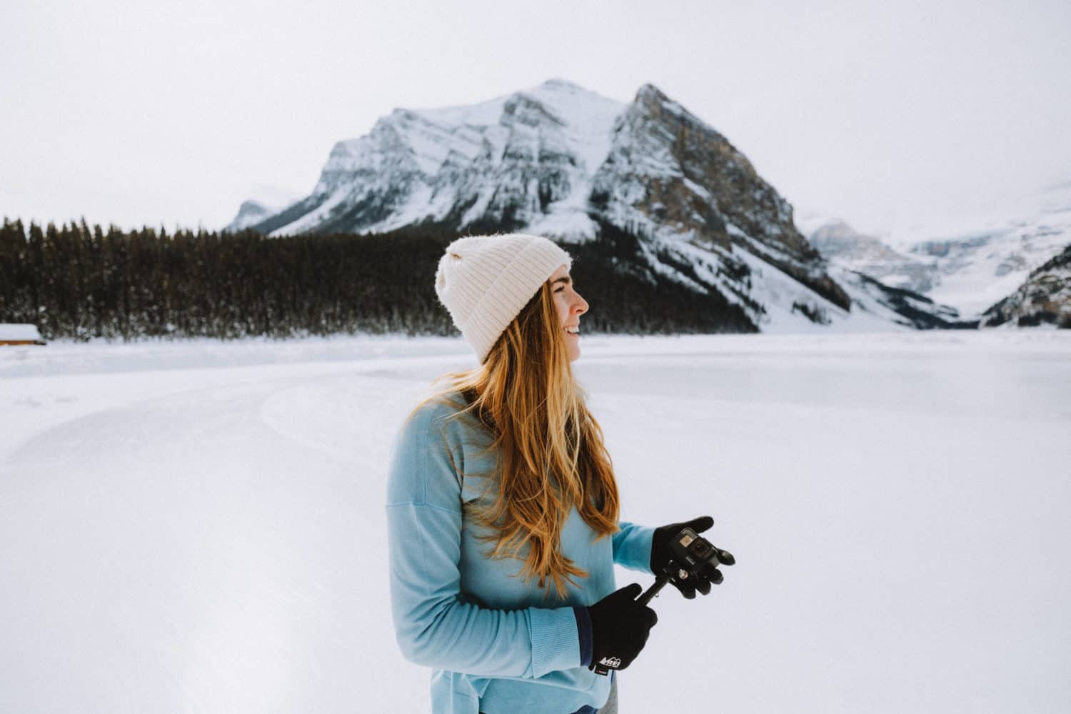 Emily wearing layers in Lake Louise - Banff winter packing list - TheMandagies.com