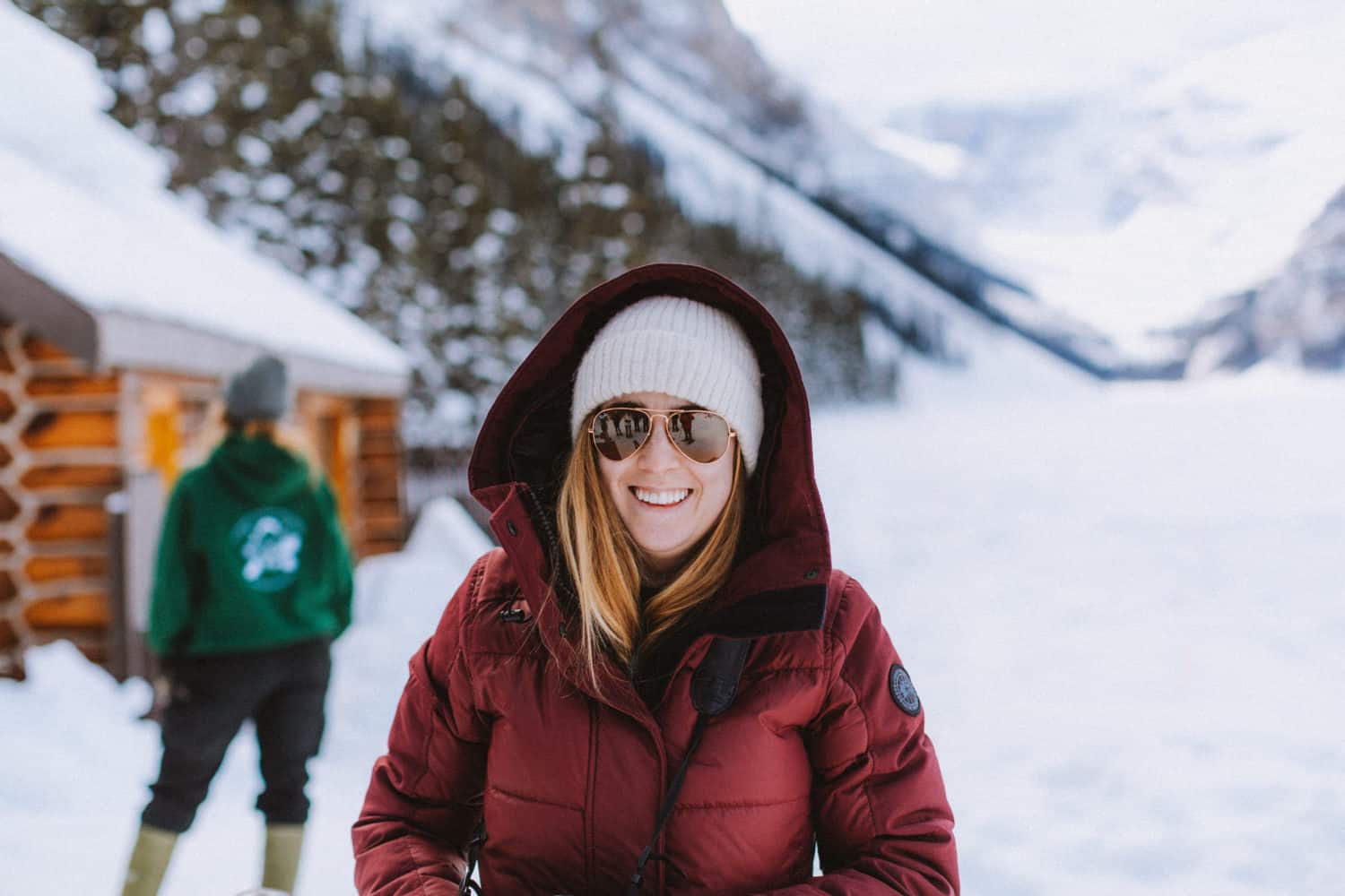 Emily wearing sunglasses at Lake Louise - Canada winter packing list - TheMandagies.com