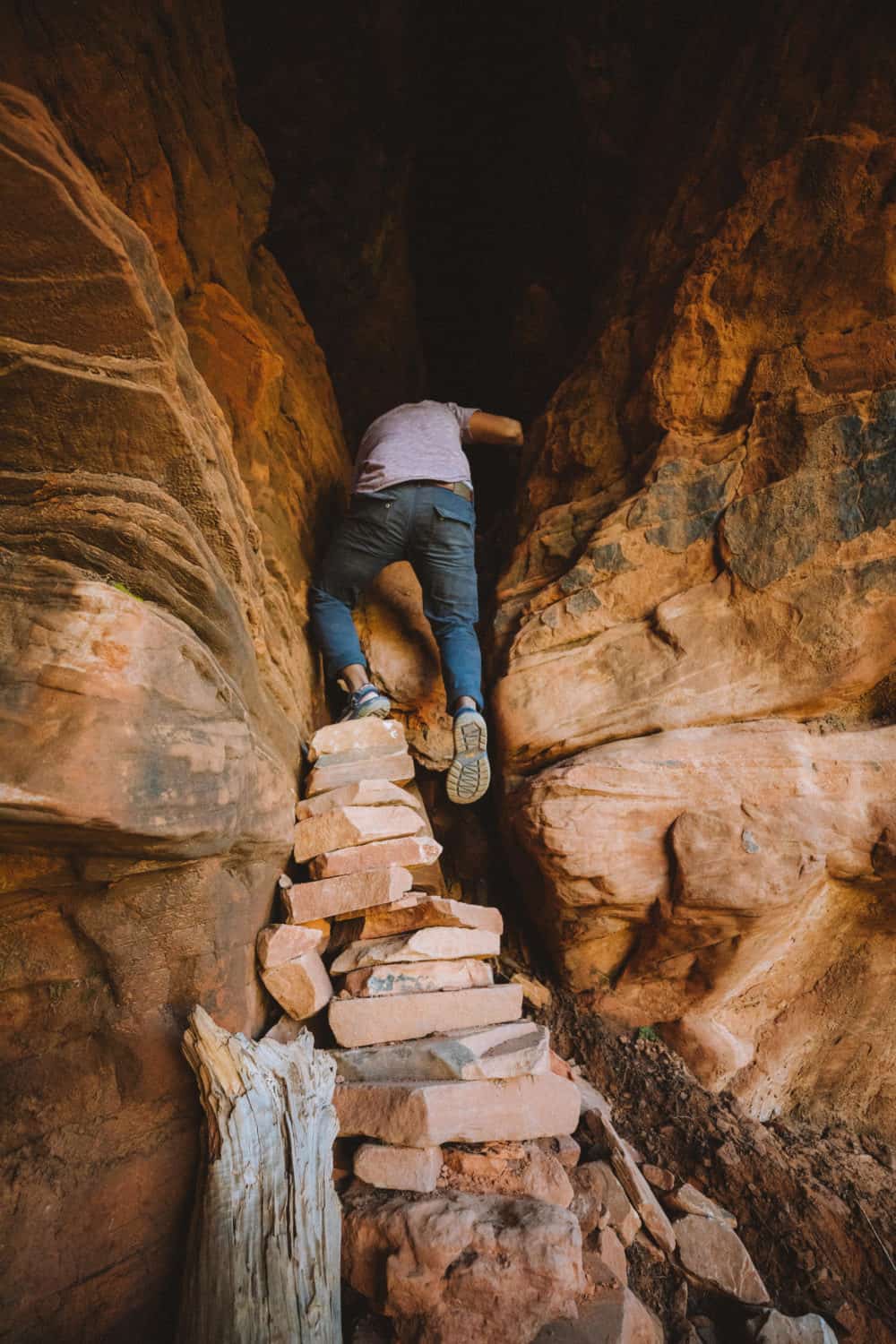 Berty Mandagie climbing into Soldiers Pass cave, Sedona