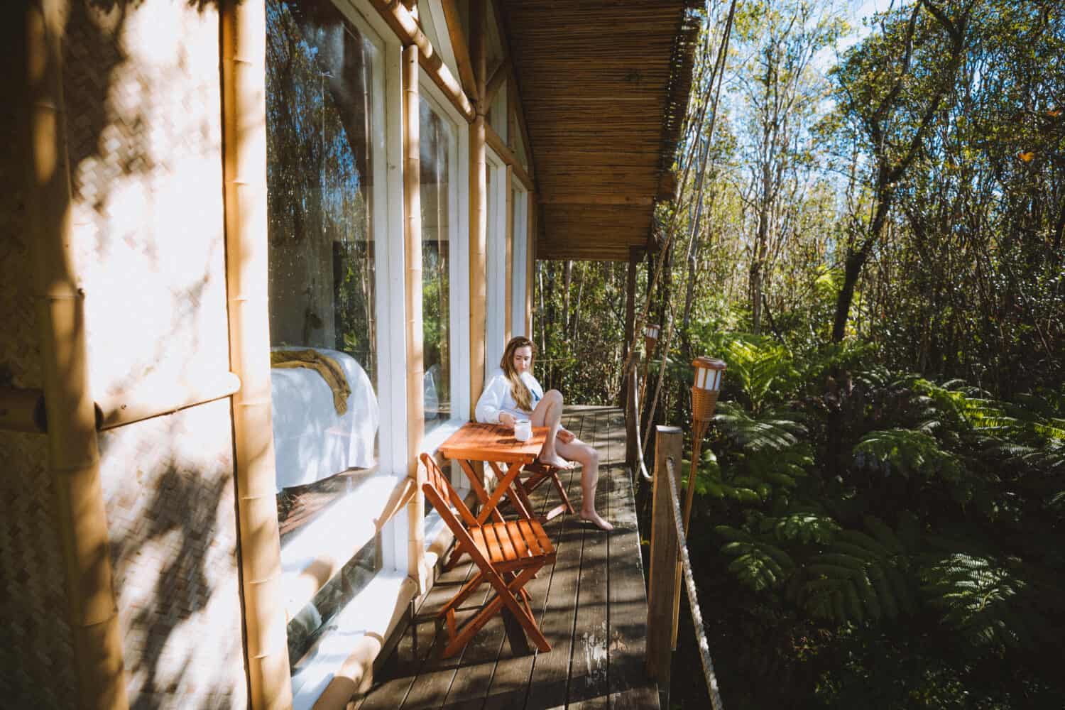 Emily sipping coffee on hawaii treehouse deck