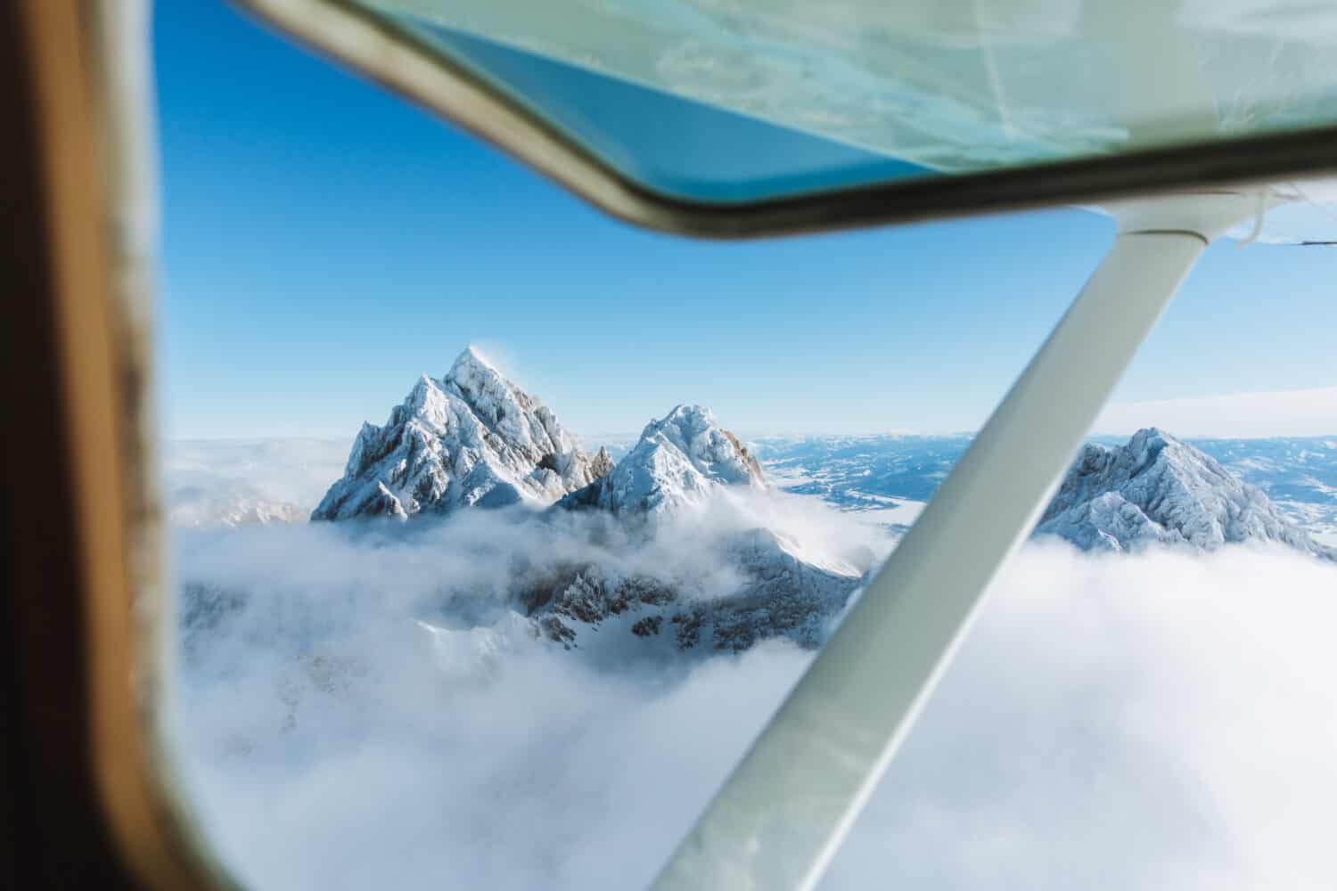 View of Grand Teton from plane window - TheMandagies.com