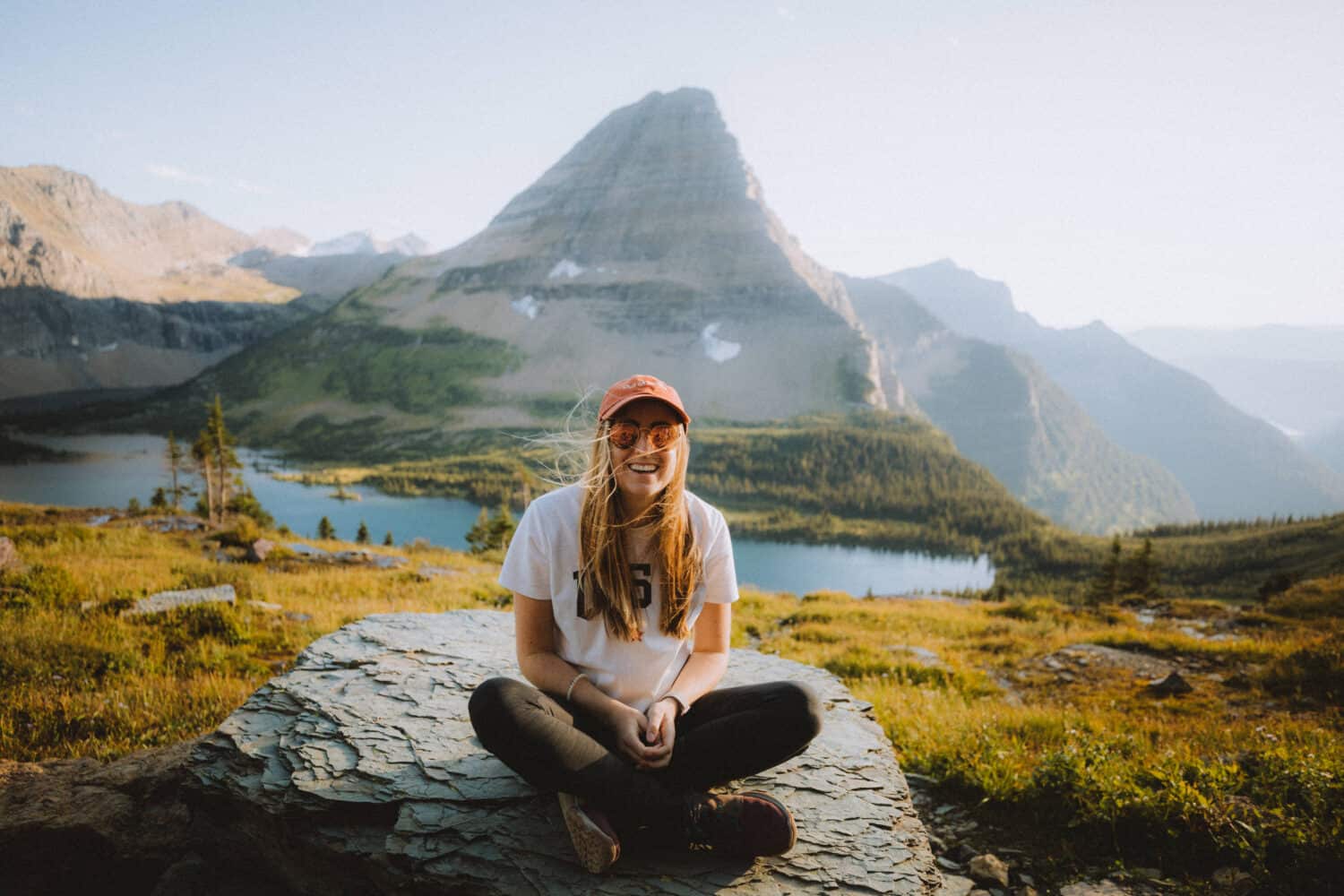 Emily Mandagie sitting on a rock at Hidden Lake Overlook in Logan Pass.