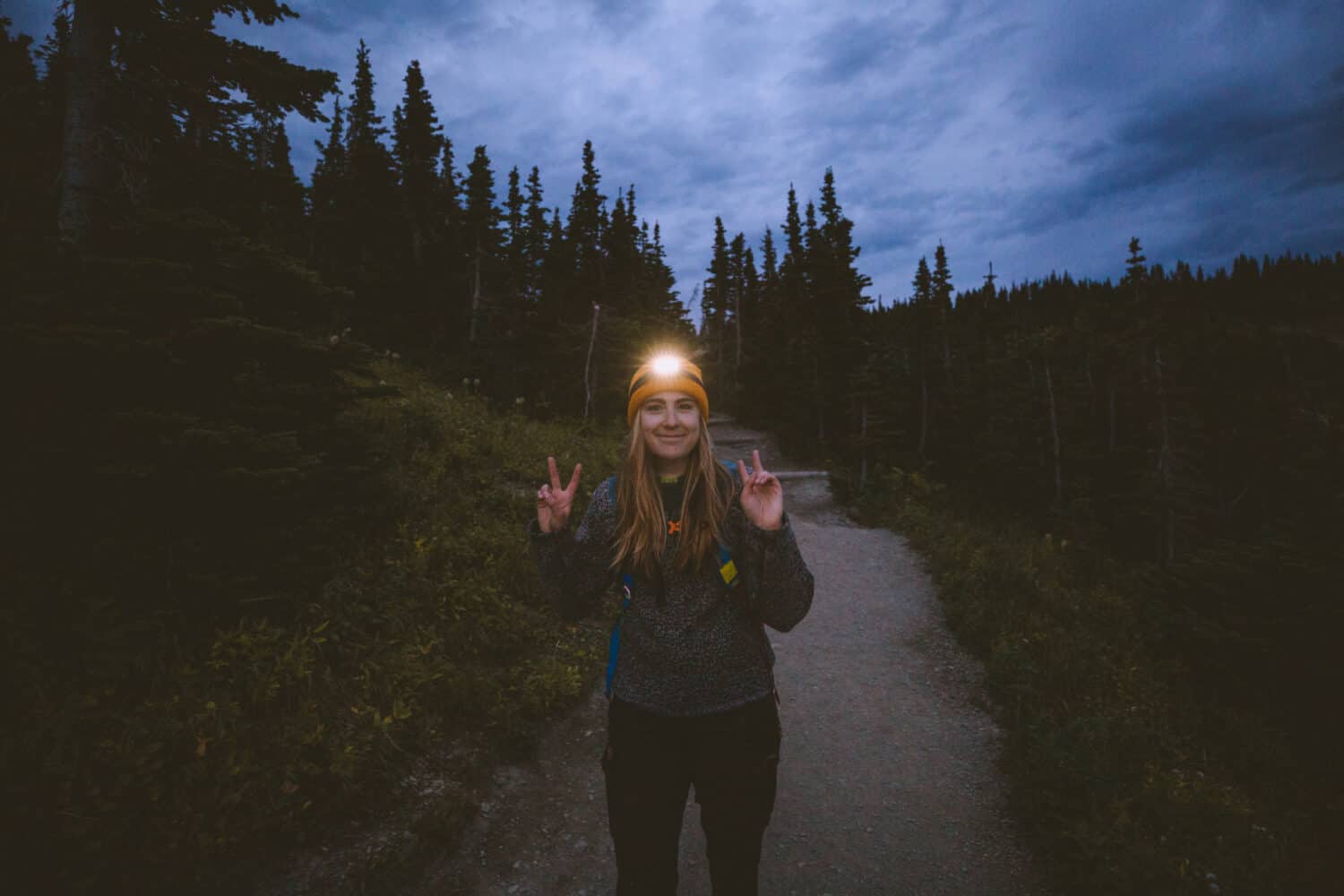 Emily Mandagie wearing headlamp during hike in Glacier National Park - TheMandagies.com