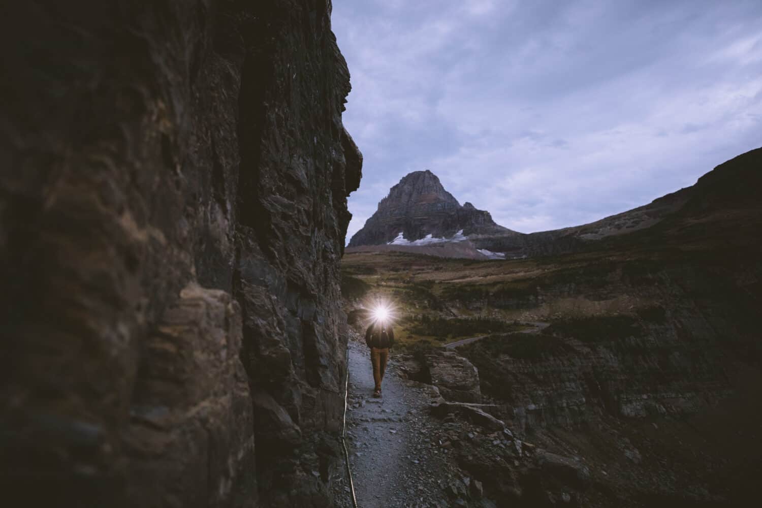 Headlamp light in the early morning on the Highline Trail in Glacier National Park.
