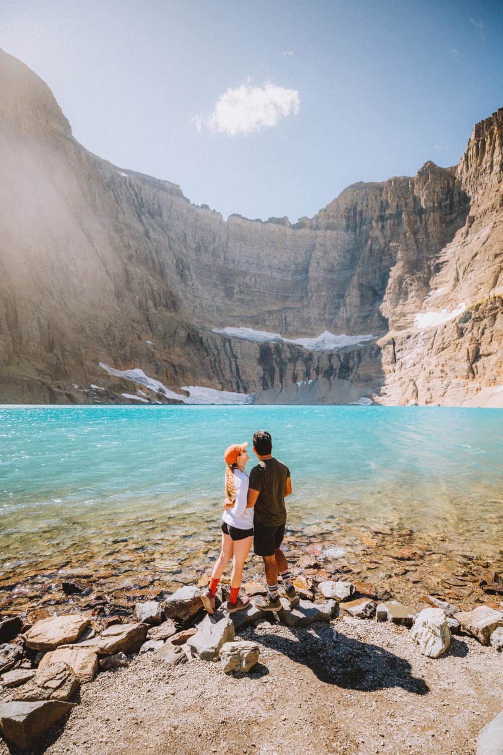 Berty and Emily Mandagie standing at Iceberg Lake Trail - best hikes in Glacier National Park - TheMandagies.com