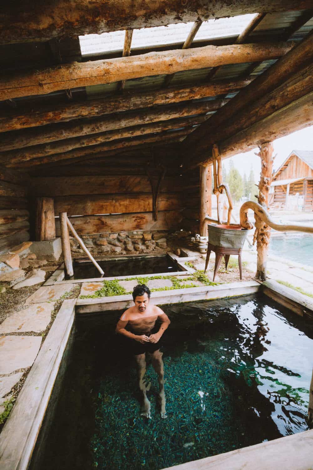 Berty Mandagie sitting in small soaking pool - Burgdorf Hot Springs -TheMandagies.com