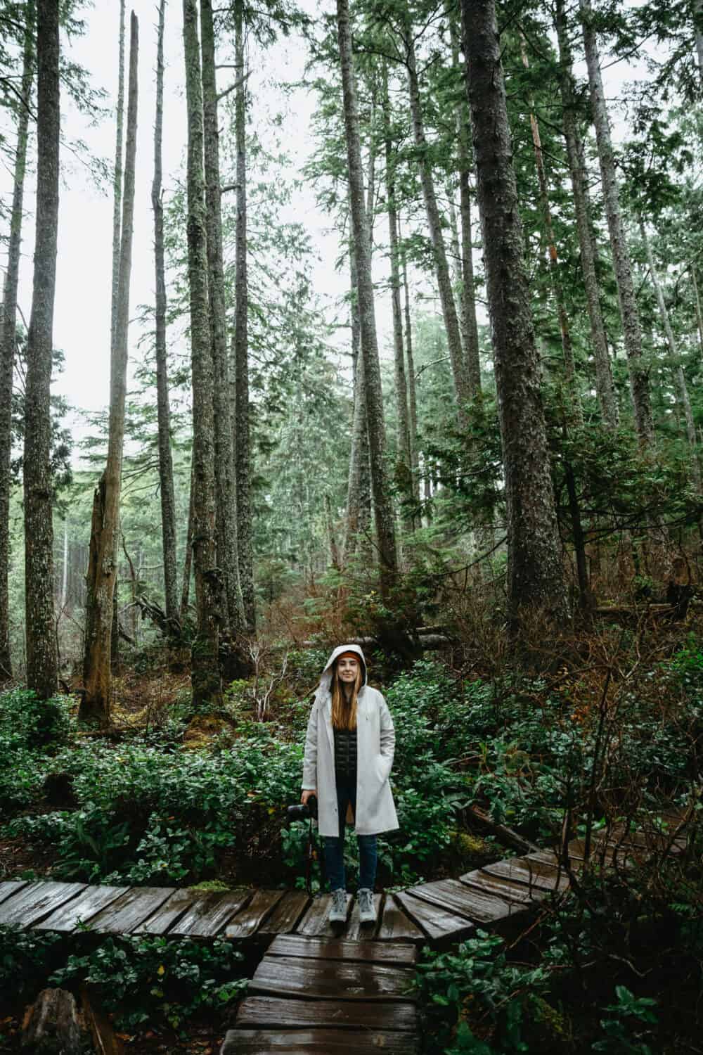 Emily Mandagie standing on the boardwalks in Cape Flattery Trail - TheMandagies.com