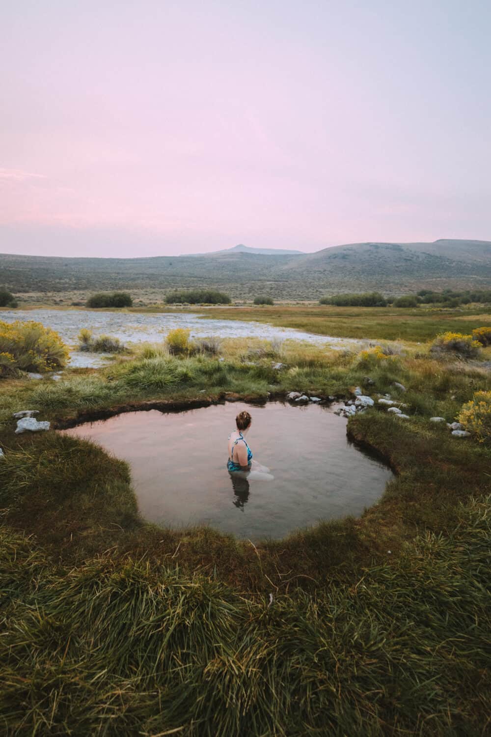 Emily Mandagie sitting in Hart Mountain Hot Springs in Eastern Oregon