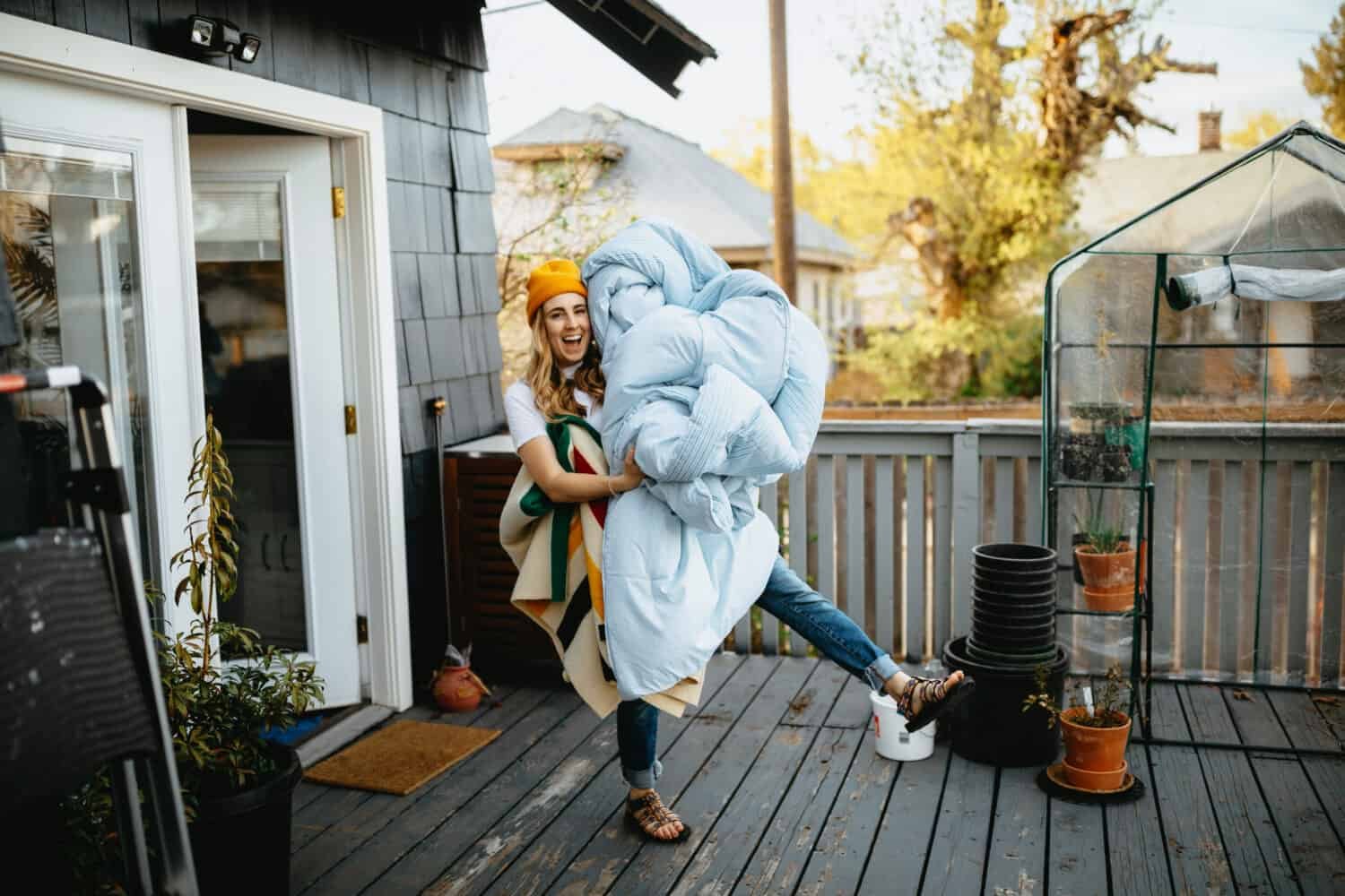 Emily Mandagie on back deck with blankets