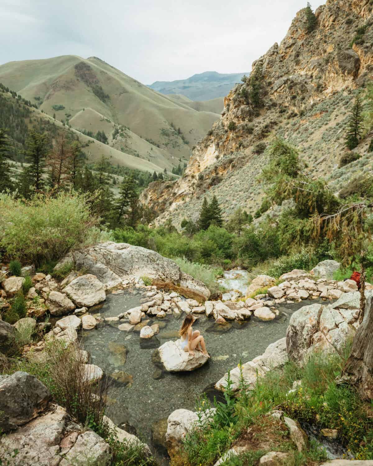 Emily Mandagie sitting at Goldbug Hot Springs