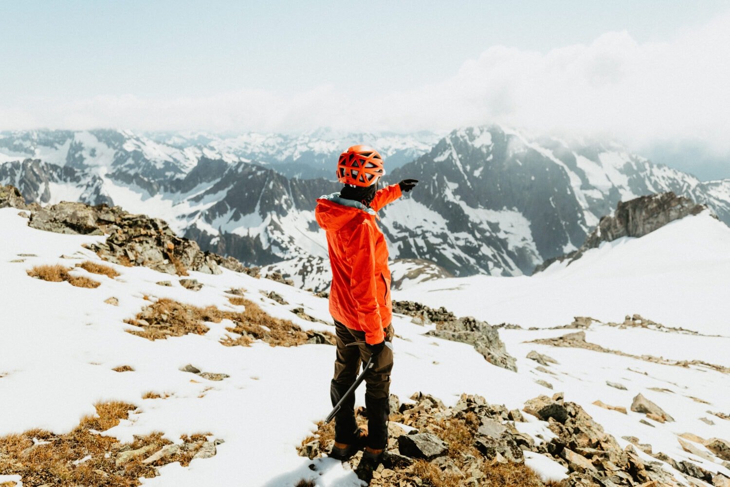 Emily Mandagie pointing at the North Cascades mountain range in Washington