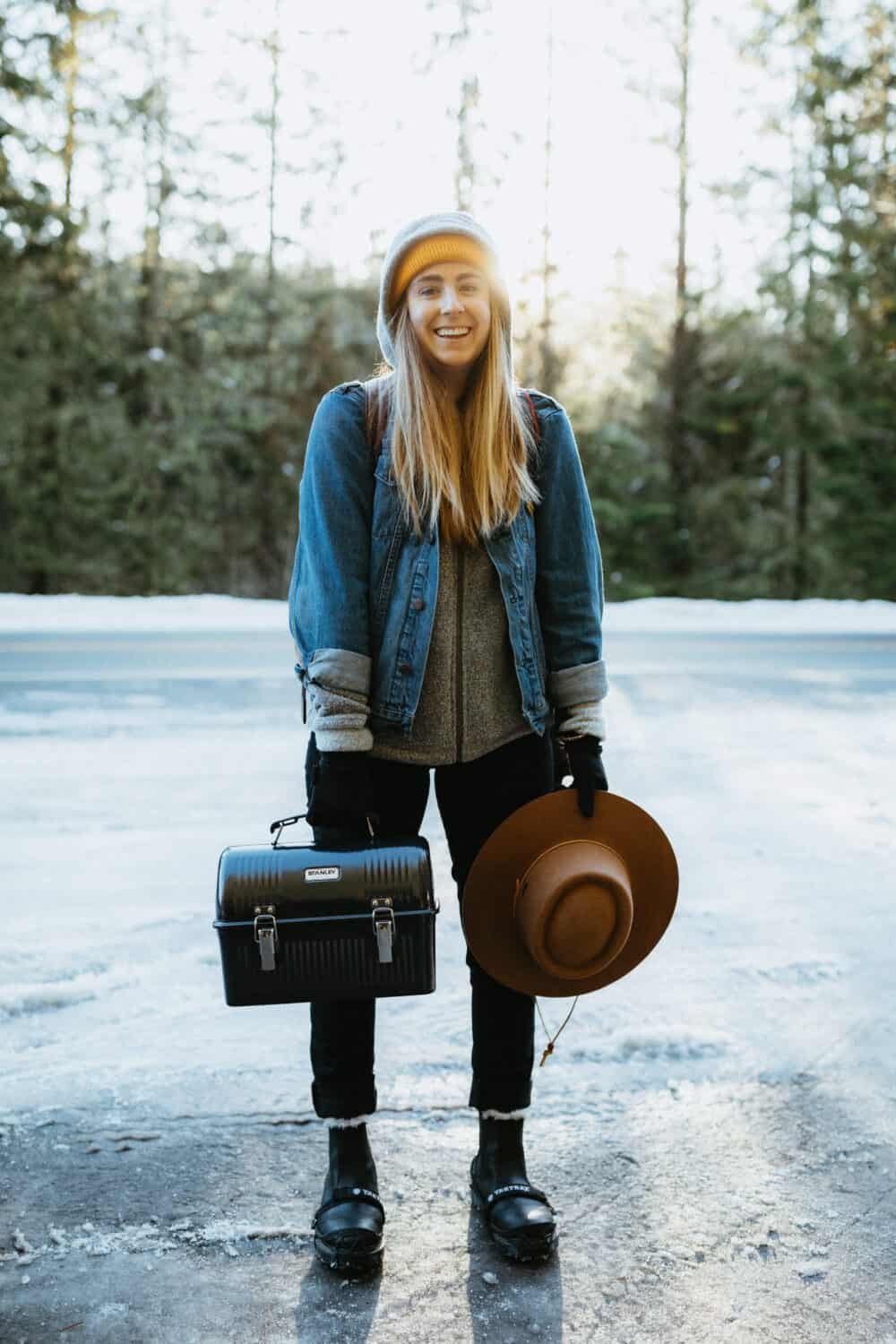 Emily Mandagie packing for a hot springs trip. Lunch box and hat