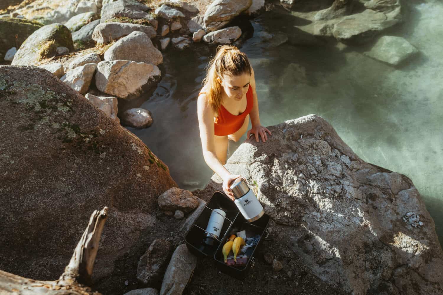 Emily Mandagie grabbing snacks at a hot spring