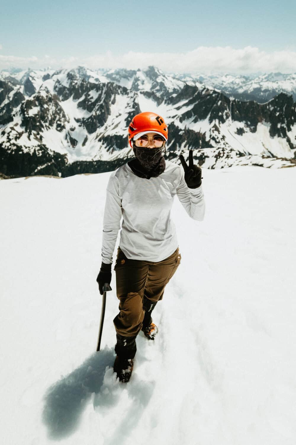 Emily Mandagie covering up from the sun, wearing gloves, helmet, sunglasses, and long sleeve shirt.