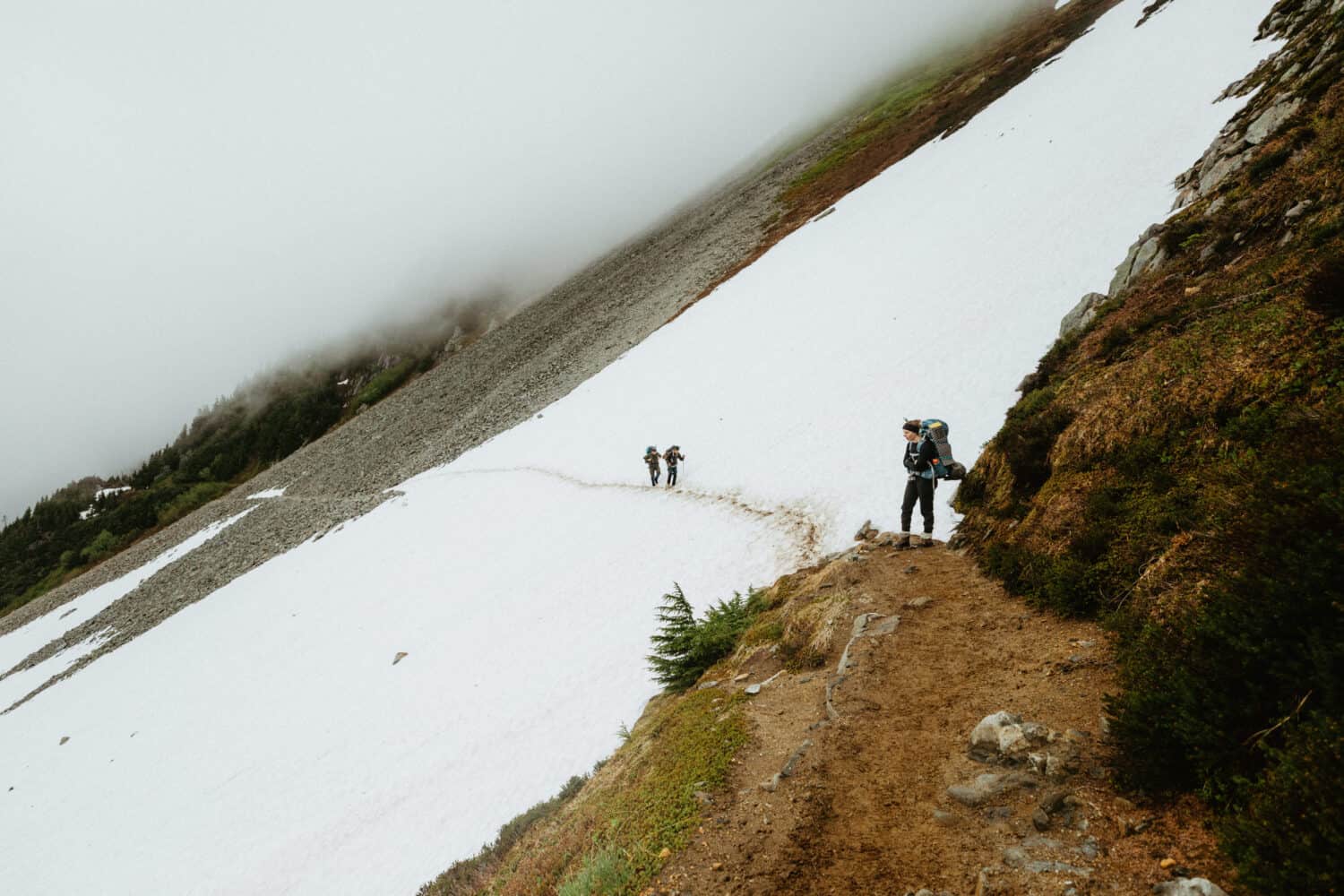 Hiking a snowy trail Cascade Pass Trail to Sahale Glacier Camp. 