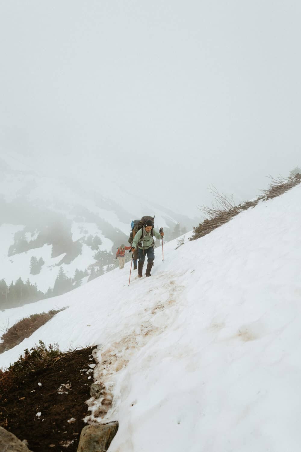 Berty Mandagie hiking in the snow in the North Cascades in July