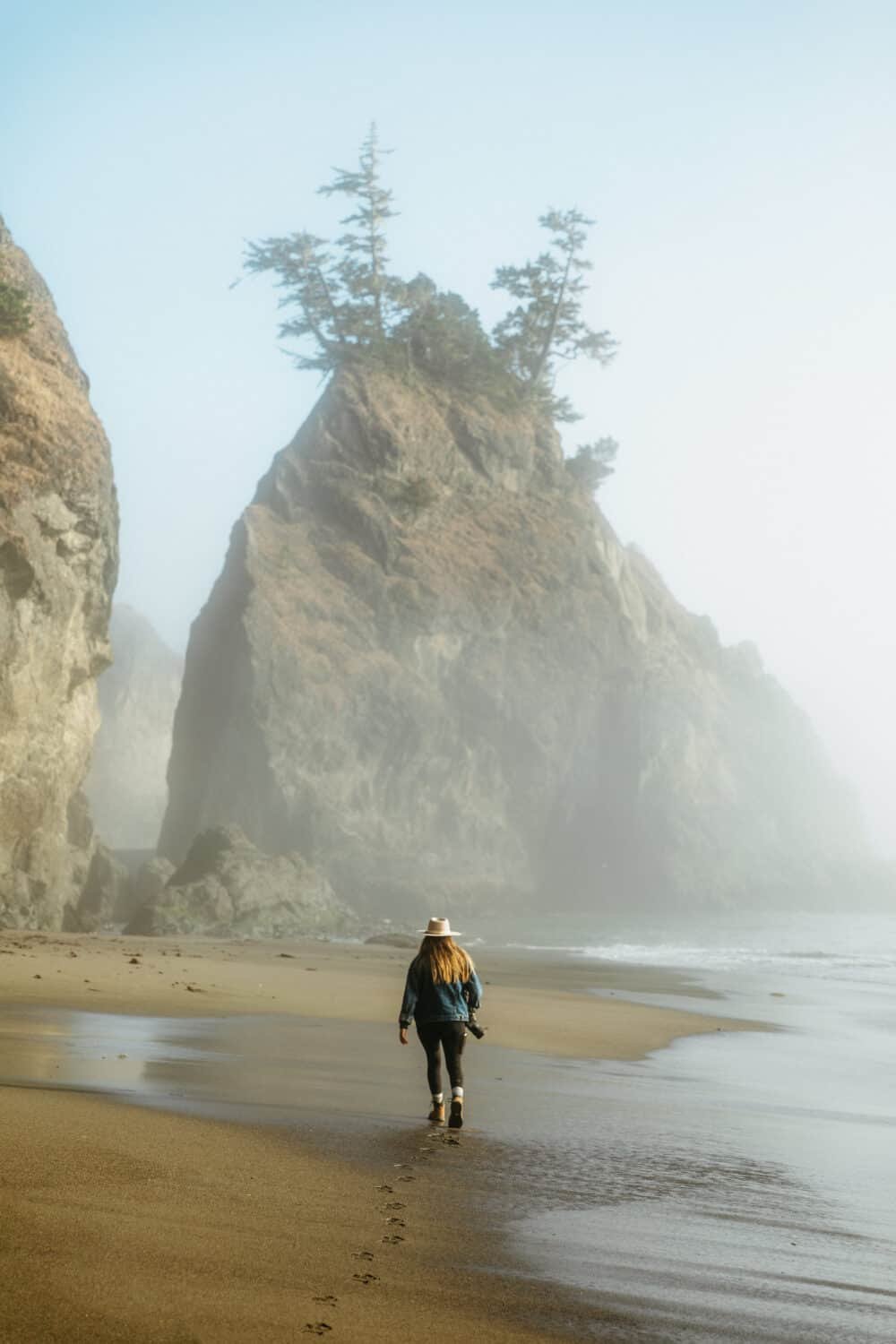 Emily Mandagie walking on the beach at Secret Beach on the Oregon Coast