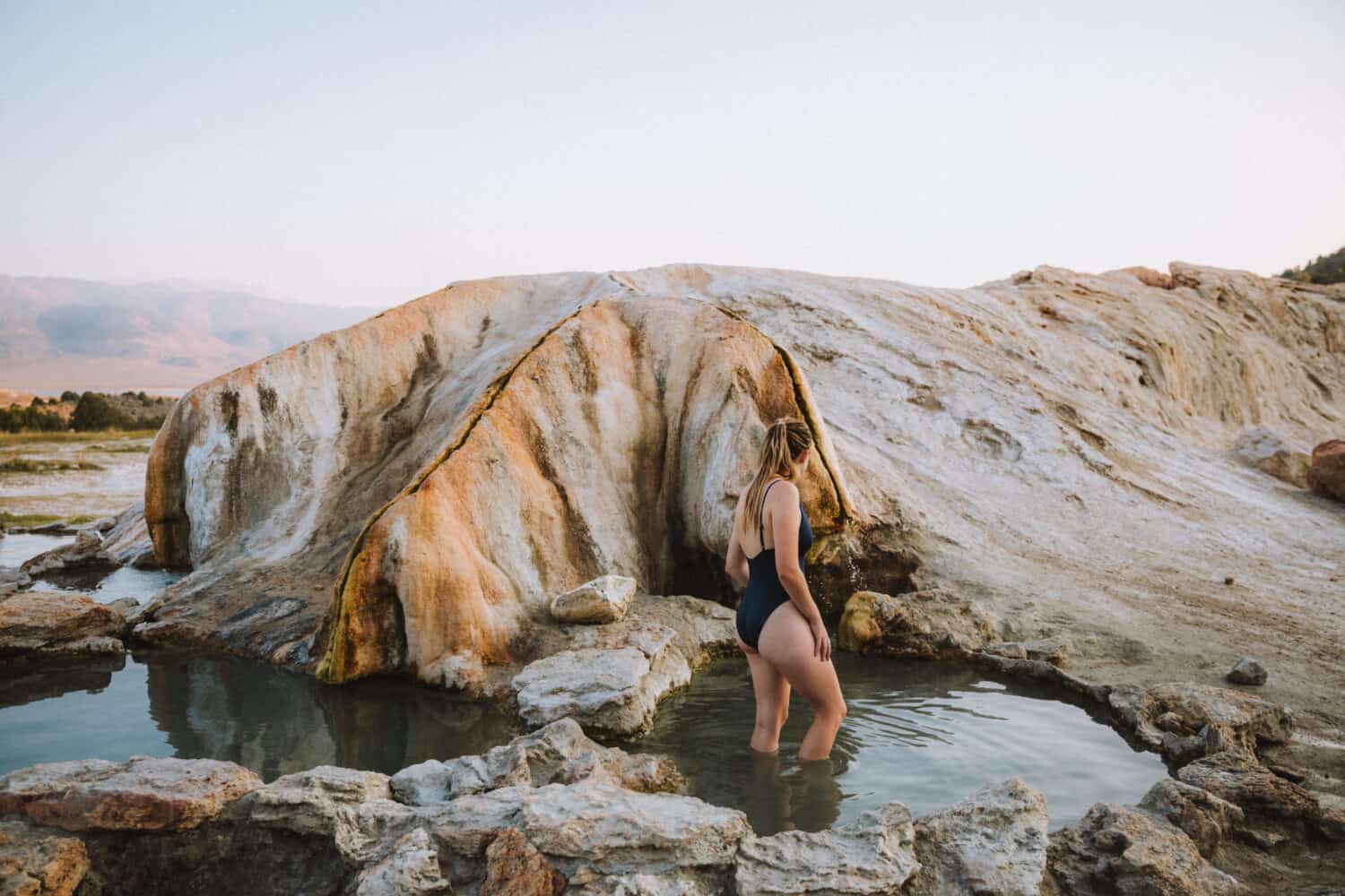 August Outdoor Holidays - Emily Mandagie soaking in Travvertine Hot Springs