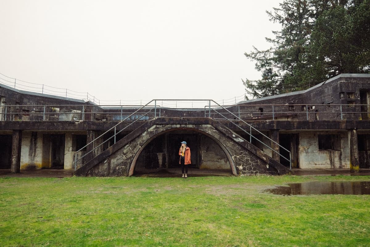 Emily Mandagie standing at Battery Russel in Fort Stevens State Park