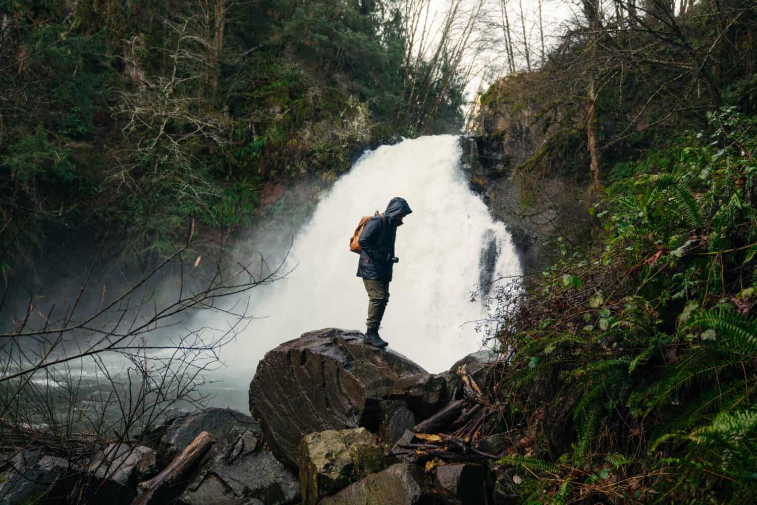 Berty Mandagie standing near Youngs River Falls on the Oregon Coast