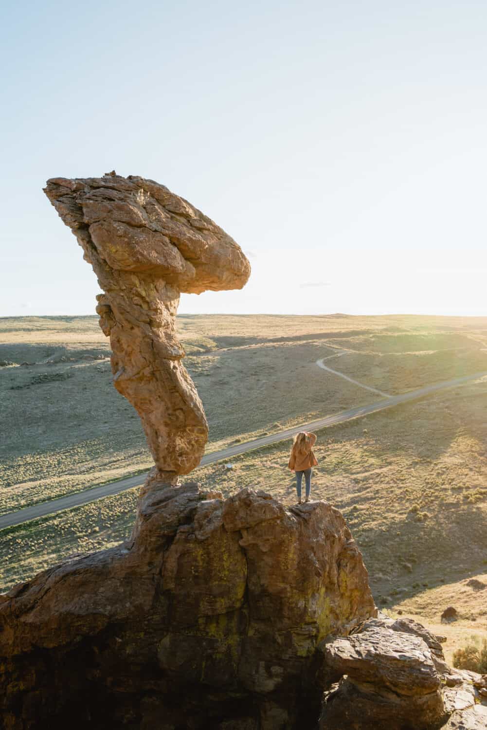 Emily Mandagie standing at Balanced Rock in Idaho