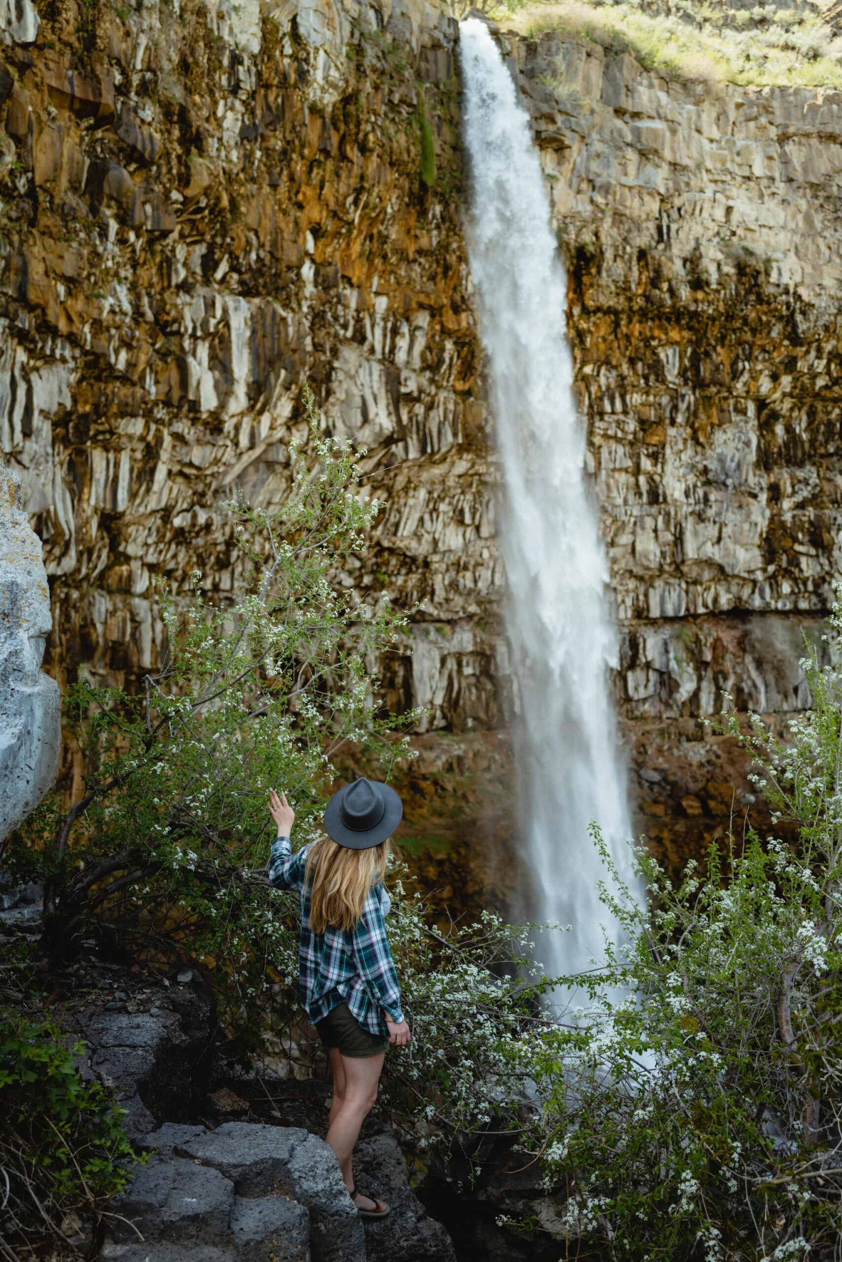 Emily Mandagie standing at base of Perrine Coulee Falls, Twin Falls Idaho