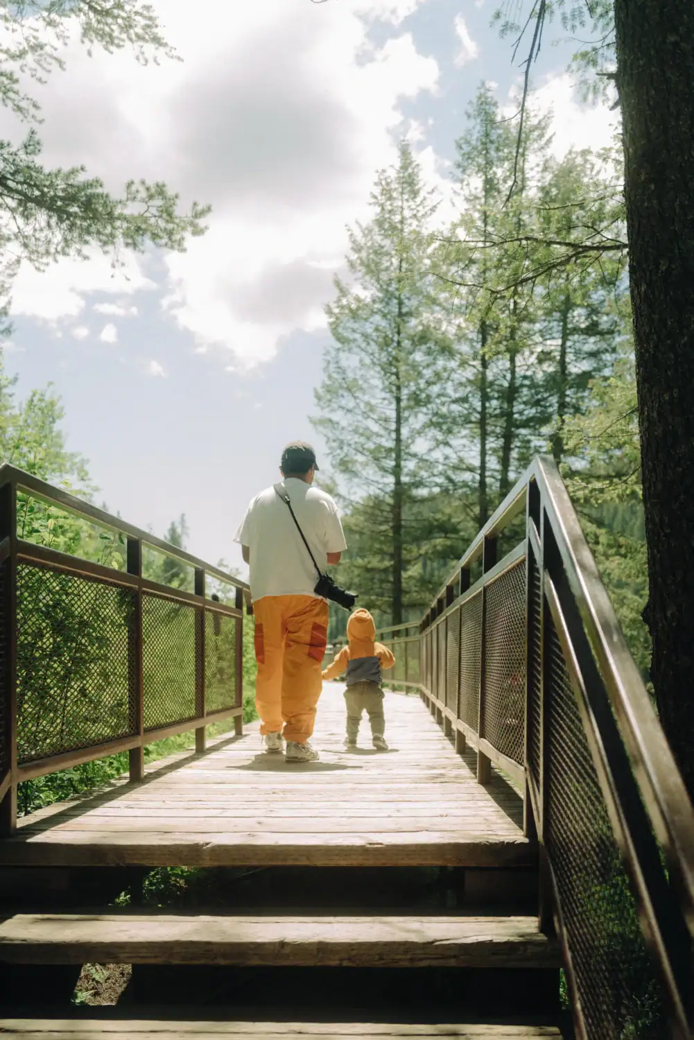 Berty Mandagie at Upper Mesa Falls Viewpoint with a toddler in Idaho Falls, Idaho