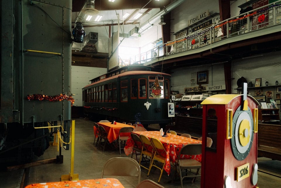 Interior of the Inland NW Rail Museum, with a historic Spokane trolley car and train memorabilia on the walls.