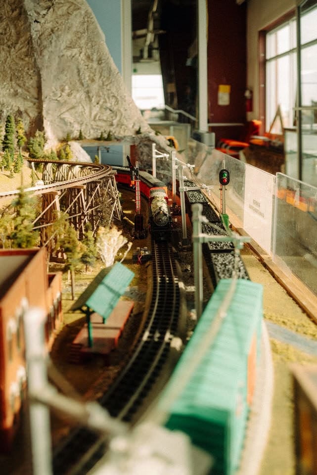 Close up view of the model trains at the Inland NW Rail Museum. Model includes a train, stop light, trestle, and train depot.
